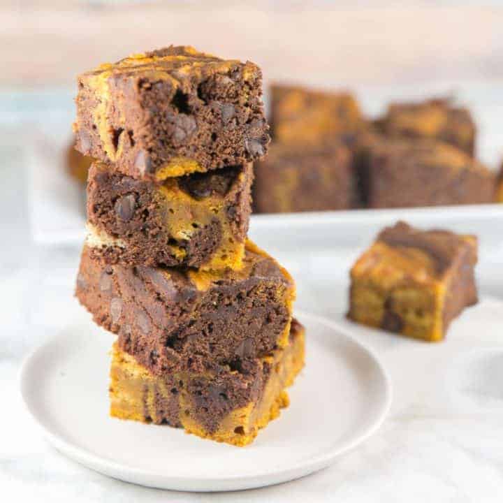 a vertical stack of brownies swirled with pumpkin puree.