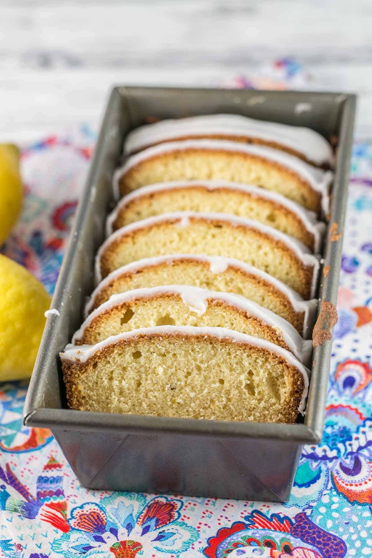 slices of lemon pound cake covered in lemon glaze sliced and arrange in a loaf pan