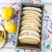 lemon pound cake with a lemon glaze sliced and arrange in a loaf pan