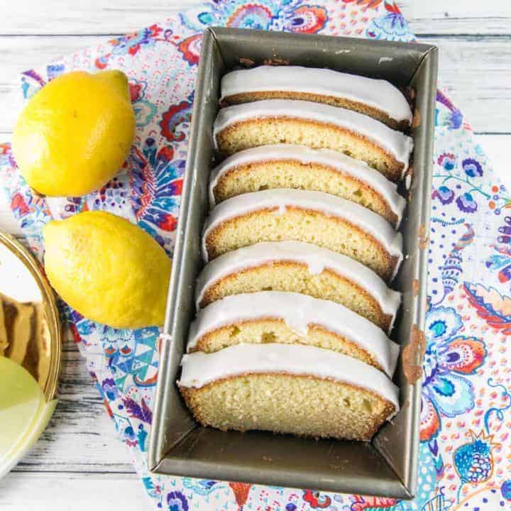 lemon pound cake with a lemon glaze sliced and arrange in a loaf pan