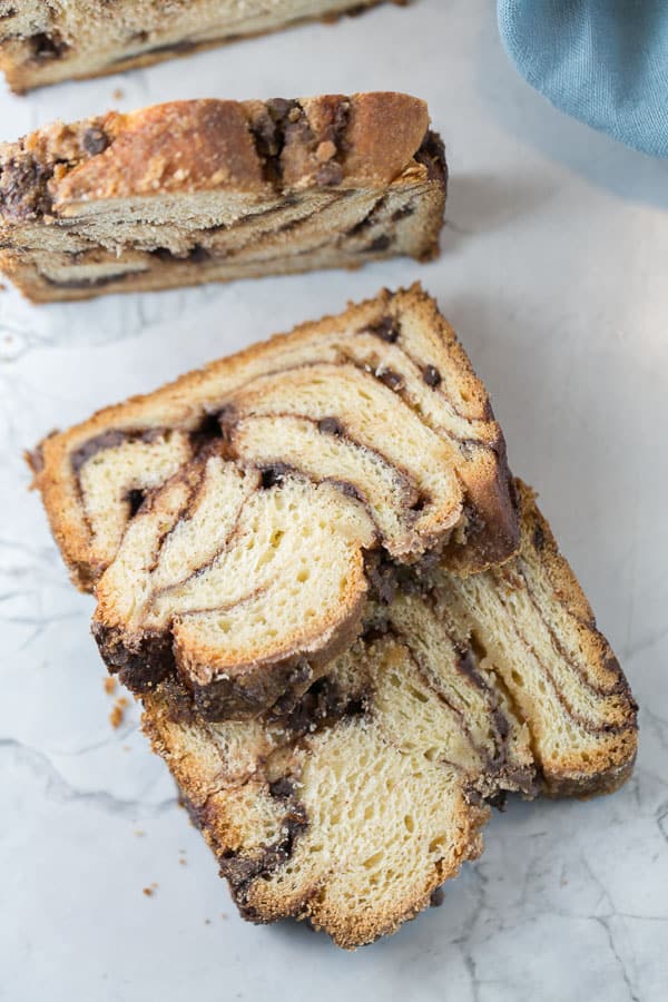 overhead view of two slices of chocolate babka focusing on the swirls of chocolate