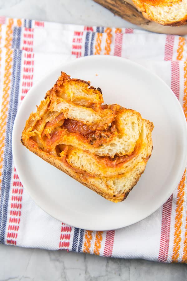 overhead view of a slice of pizza babka on a white plate