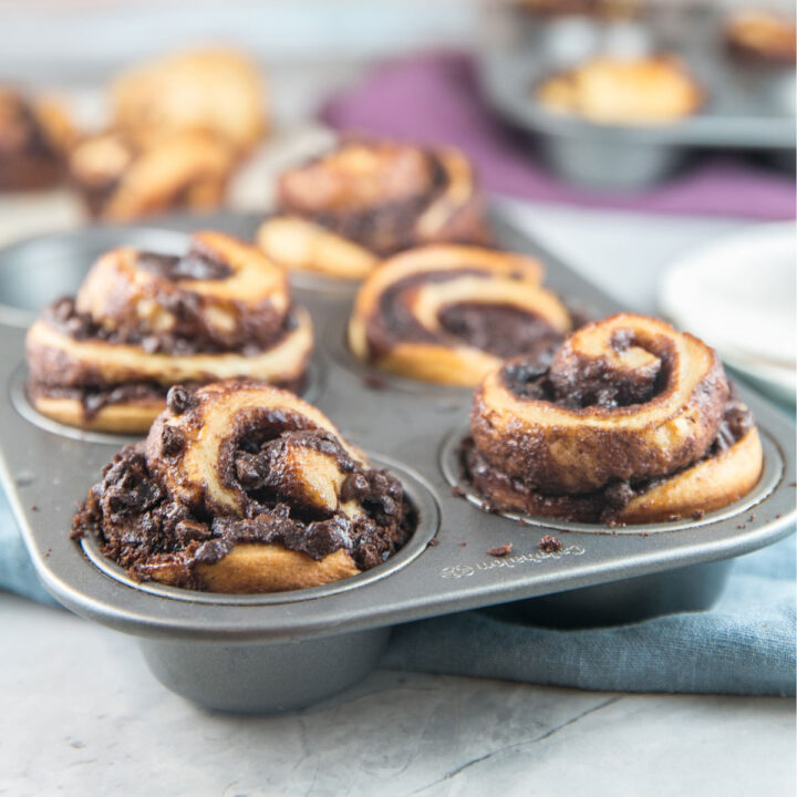 babka muffins filled with chocolate and cinnamon in the muffin tin