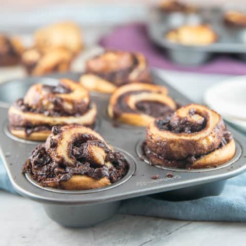 Cinnamon Chocolate Babka Muffins: A rich, buttery yeast dough, filled with beautiful swirls of chocolate and baked in individual sizes in a muffin tin. Same great babka taste, baked in half the time! #bunsenburnerbakery #babka #muffins #chocolatebabka #yeastbread