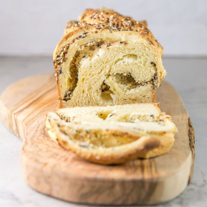 sliced loaf of everything bagel babka showing the interior cream cheese swirl
