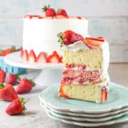 Strawberry Layer Cake with Whipped Cream Frosting: Perfect for all your summer celebrations, this strawberry layer cake is made entirely with real strawberries and filled with thick layers of homemade strawberry puree. #bunsenburnerbakery #cake #layercake #strawberrycake #strawberries