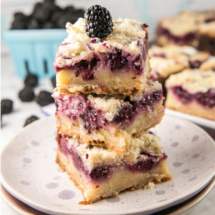 stack of blackberry pie bars on a dessert plate