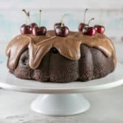 Chocolate Cherry Bundt Cake: An easy recipe for homemade chocolate cherry cake covered in fudge frosting made entirely from scratch! Use fresh or frozen cherries to make this cake year round for birthdays and other celebrations. #bunsenburnerbakery #bundtcake #chocolatecake #fudgefrosting #chocolatecherrycake