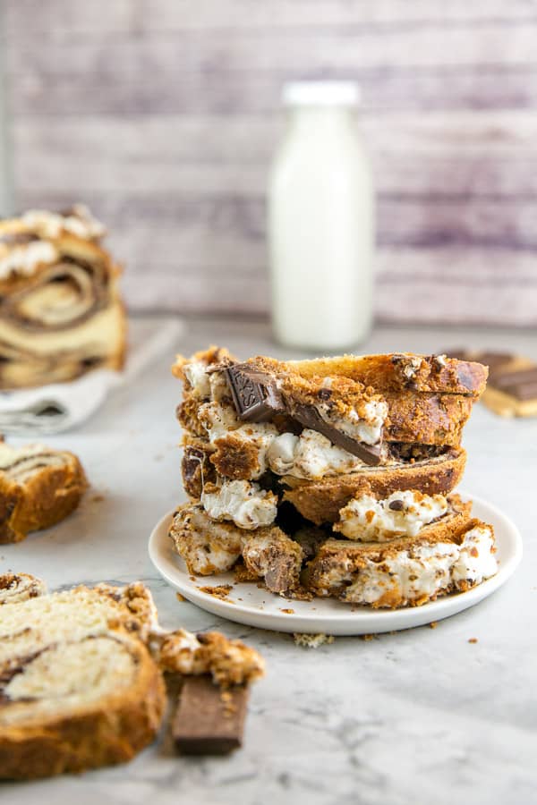 a stack of slices of s'mores babka showing the toasted marshmallow topping
