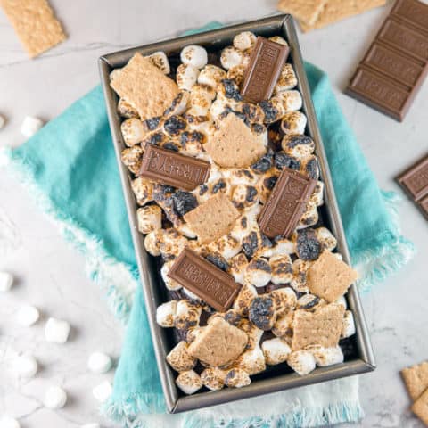 S'mores Quick Bread: Love s'mores?  Bring the graham cracker, chocolate, and toasted marshmallow combination indoors with this easy and fun dessert recipe!  An easy mix-by-hand chocolate graham cracker cake is topped with toasted marshmallow for a delicious, gooey treat! #bunsenburnerbakery #smores #quickbread #chocolate #marshmallows