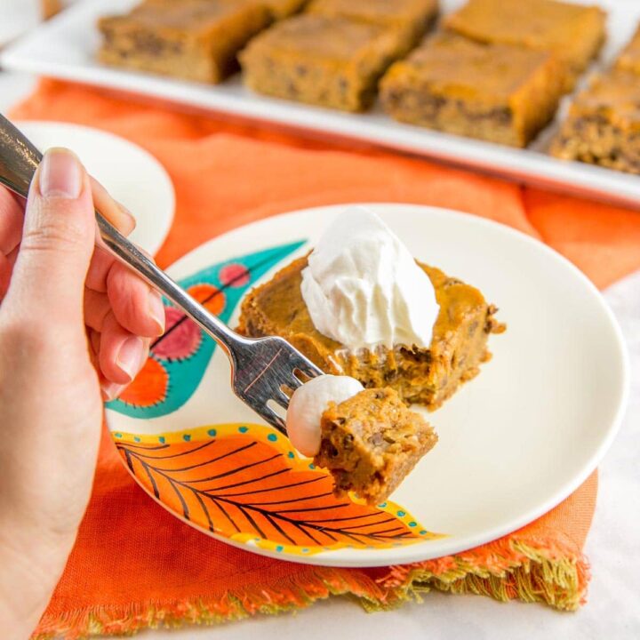 pumpkin pie bar on a fall plate with a fork digging in