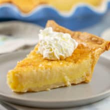 Bourbon Buttermilk Pie: This easy buttermilk pie recipe is an old fashioned southern staple - with a generous splash of of bourbon for a little extra punch! Don't forget to top with a dollop of bourbon-spiked whipped cream! #bunsenburnerbakery #pie #buttermilkpie #bourbon #boozydesserts