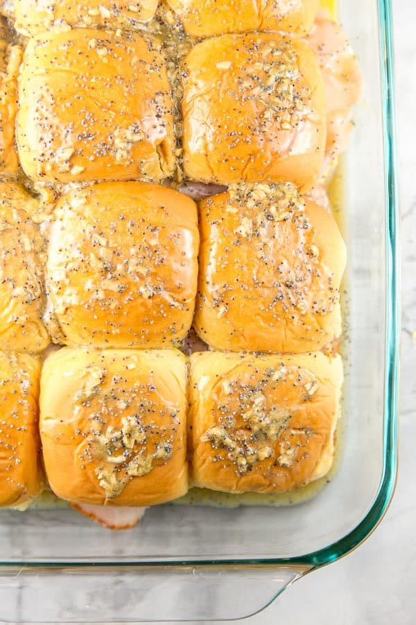 hawaiian rolls spread with seasoned butter mixture to make ham and cheese sliders