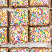 Frosted Sprinkle Brownies: These easy homemade fudgy and chewy brownies are better than boxed mix, but just as easy!  And the best part?  The rich and creamy chocolate frosting and colorful sprinkles!  Loved by kids and adults alike! #bunsenburnerbakery #brownies #frosting #chocolate #sprinkles