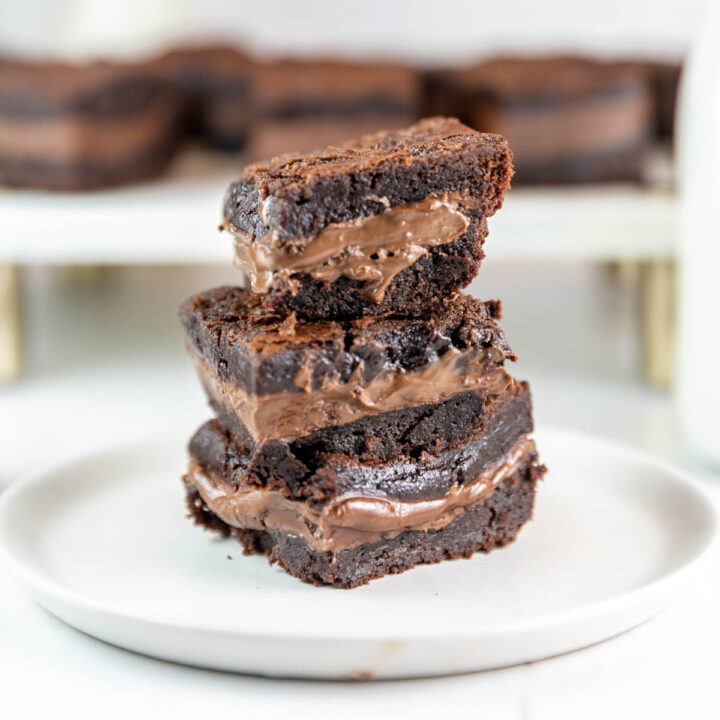 stack of three brownies filled with nutella on a small plate