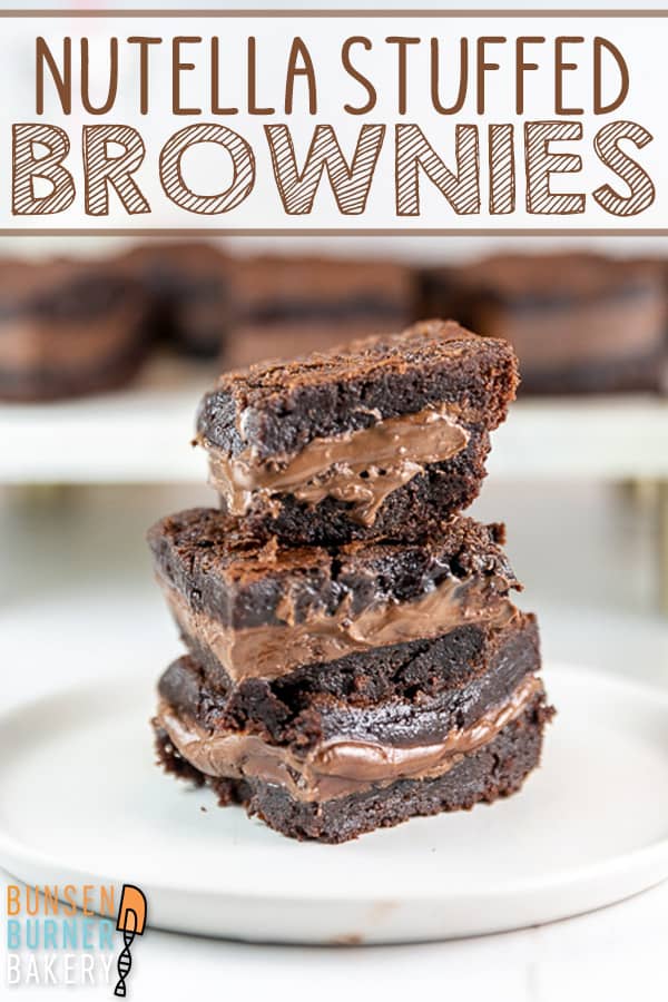 Ultimate Nutella Brownies: Take your brownies up a level with a layer of gooey Nutella baked right inside! With Nutella mixed in the batter and sandwiched in the middle, these easy made from scratch brownies are truly the best! #bunsenburnerbakery #brownies #nutella #nutellabrownies
