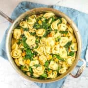 One Pot Tortellini with Sweet Potatoes and Spinach: It doesn't get any easier than this all-in-one skillet recipe filled with tortellini, sweet potatoes, spinach, beans, and peas!  Serve as is for a filling vegetarian meatless meal, or add sausage for a protein boost. #bunsenburnerbakery #tortellini #onepot #easydinner
