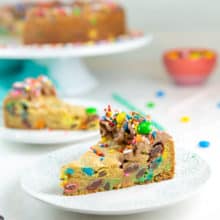 two slices of m&m cookie cake on dessert plates