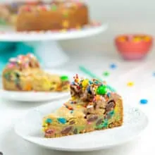 two slices of m&m cookie cake on dessert plates