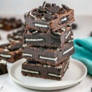 brownies stuffed with oreos stacked on a plate