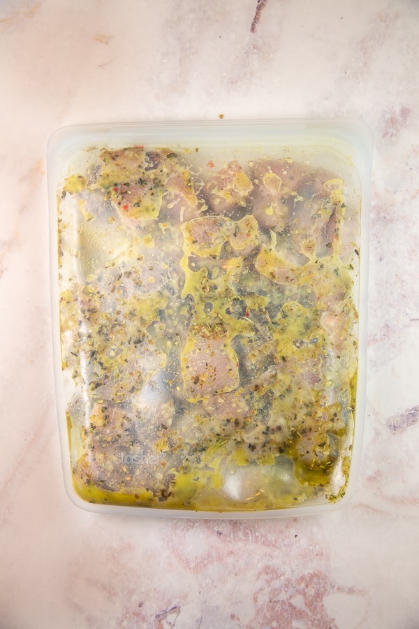 chicken marinating in a reusable freezer bag