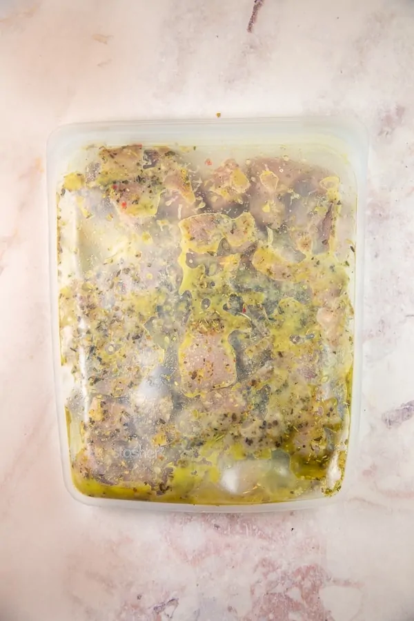 chicken marinating in a reusable freezer bag
