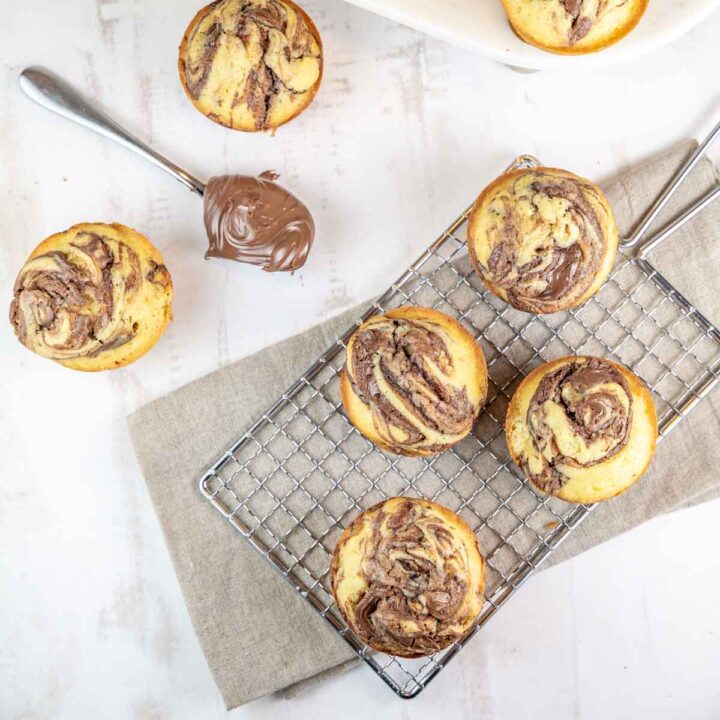 cupcakes with swirls of nutella baked into the top on a cooling rack