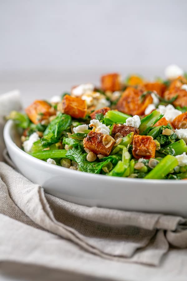 spicy squash salad in a while bowl on a linen napkin.