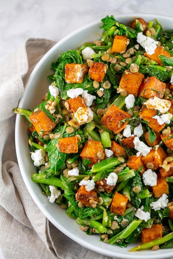 fall salad with butternut squash, leafy greens, lentils, and goat cheese.