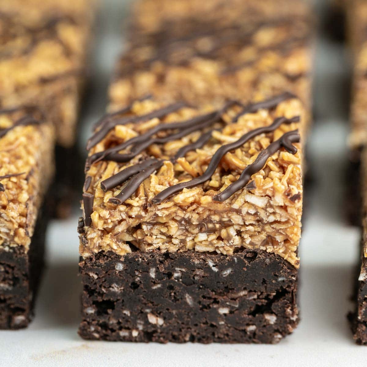 side view of a thick brownie with a coconut caramel topping