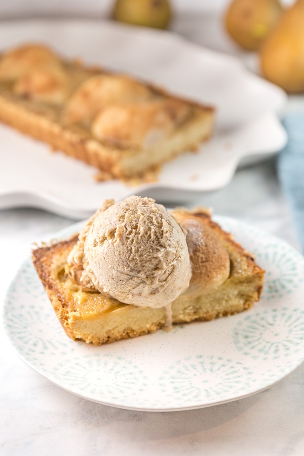 rectangular slice of pear tart with a scoop of homemade ice cream on top