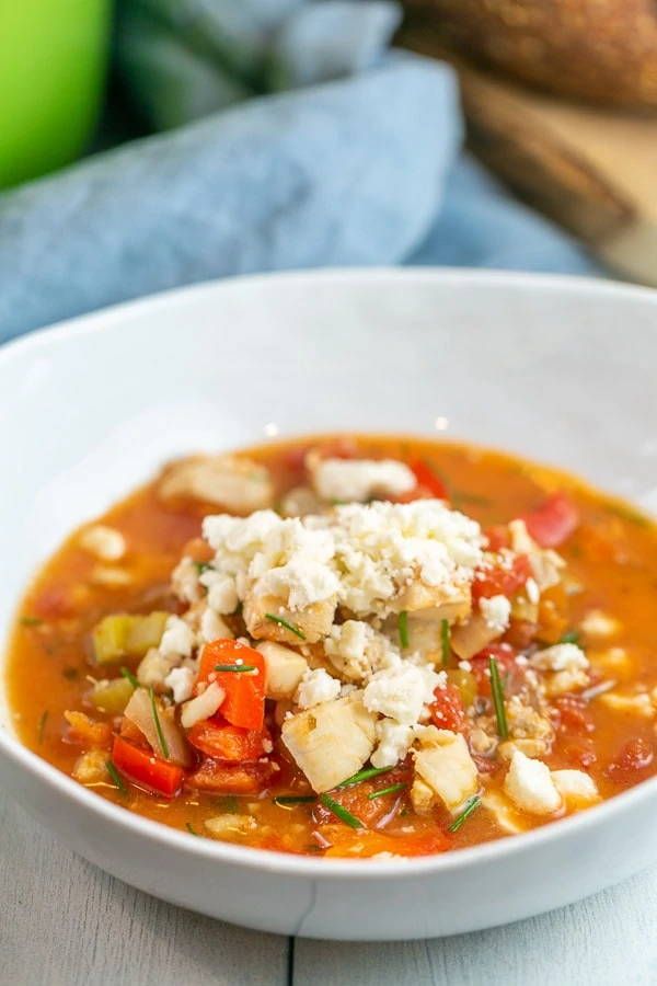 bowl of soup topped with crumbled feta and chives