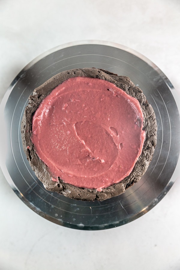 raspberry curd spread on a layer of chocolate cake