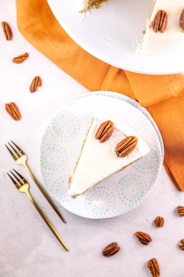 overhead view of a single slice of cake covered in cream cheese frosting