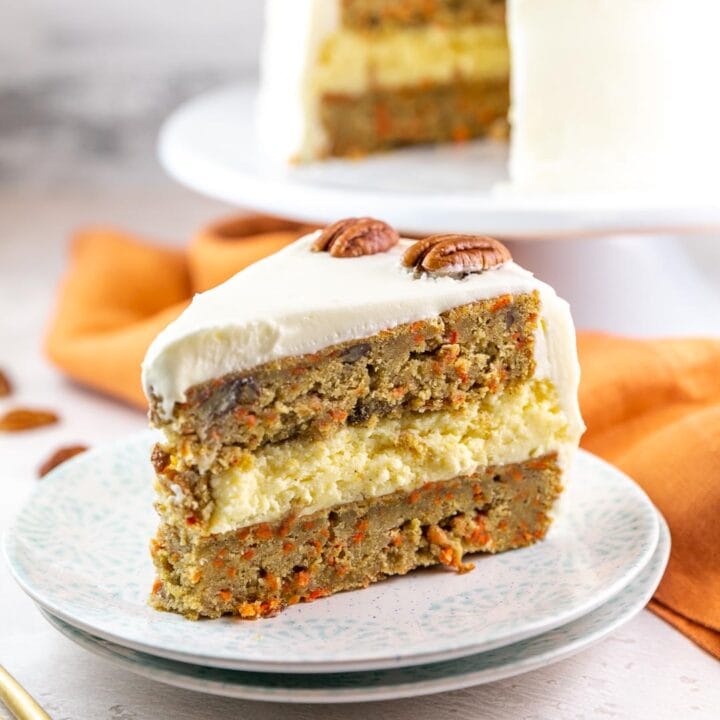 carrot cake cheesecake cake with two layers of carrot cake and a cheesecake in the middle