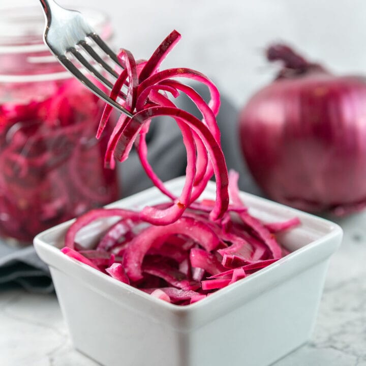 thinly slice pickled red onions on a fork