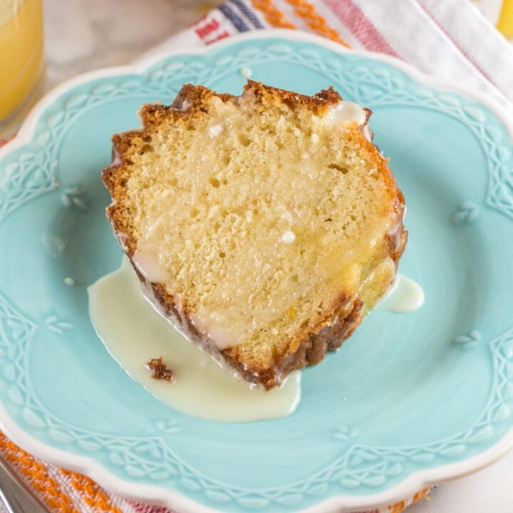 slice of orange bundt cake covered with an orange glaze