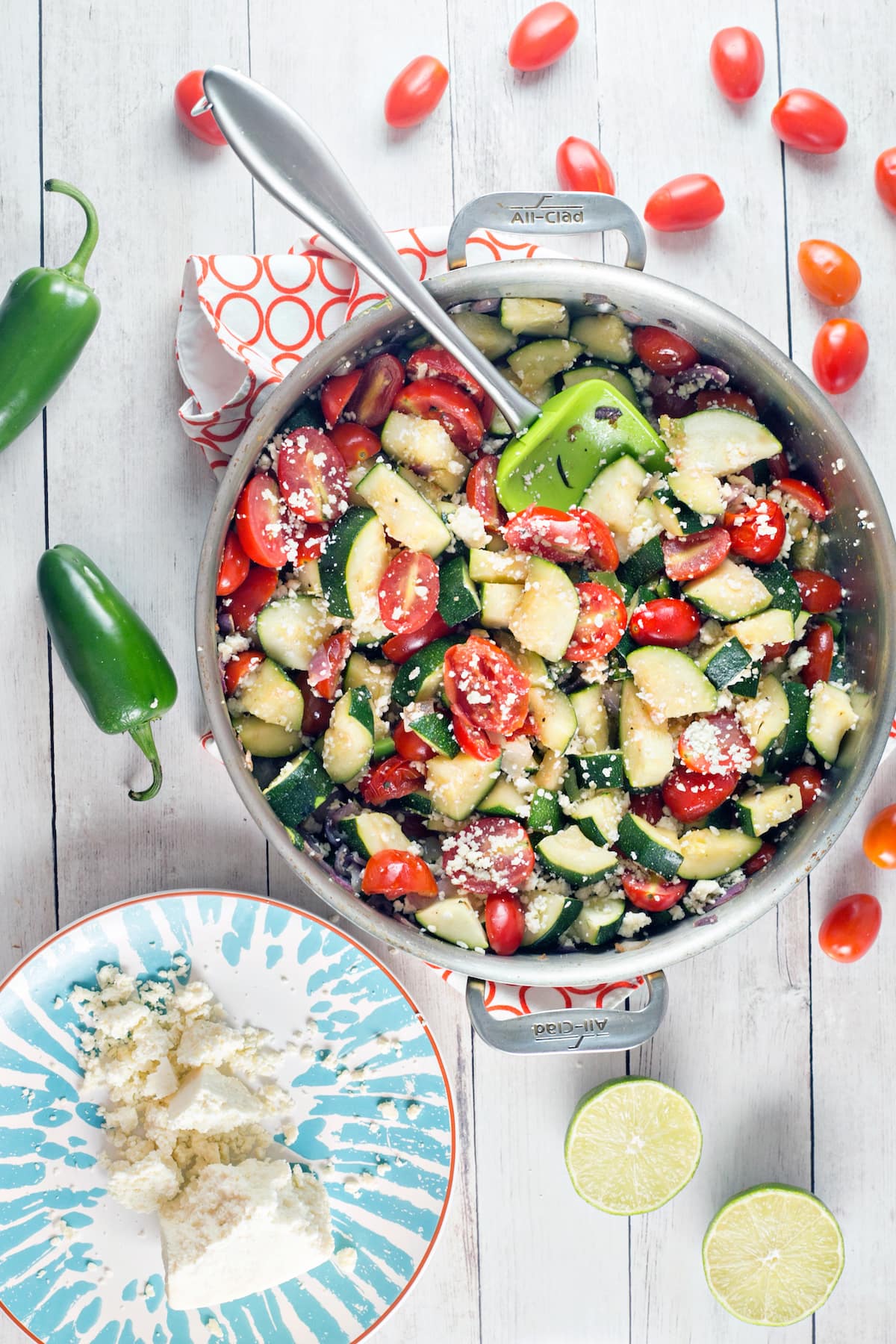 large skillet full of zucchini, tomatoes, and jalapenos