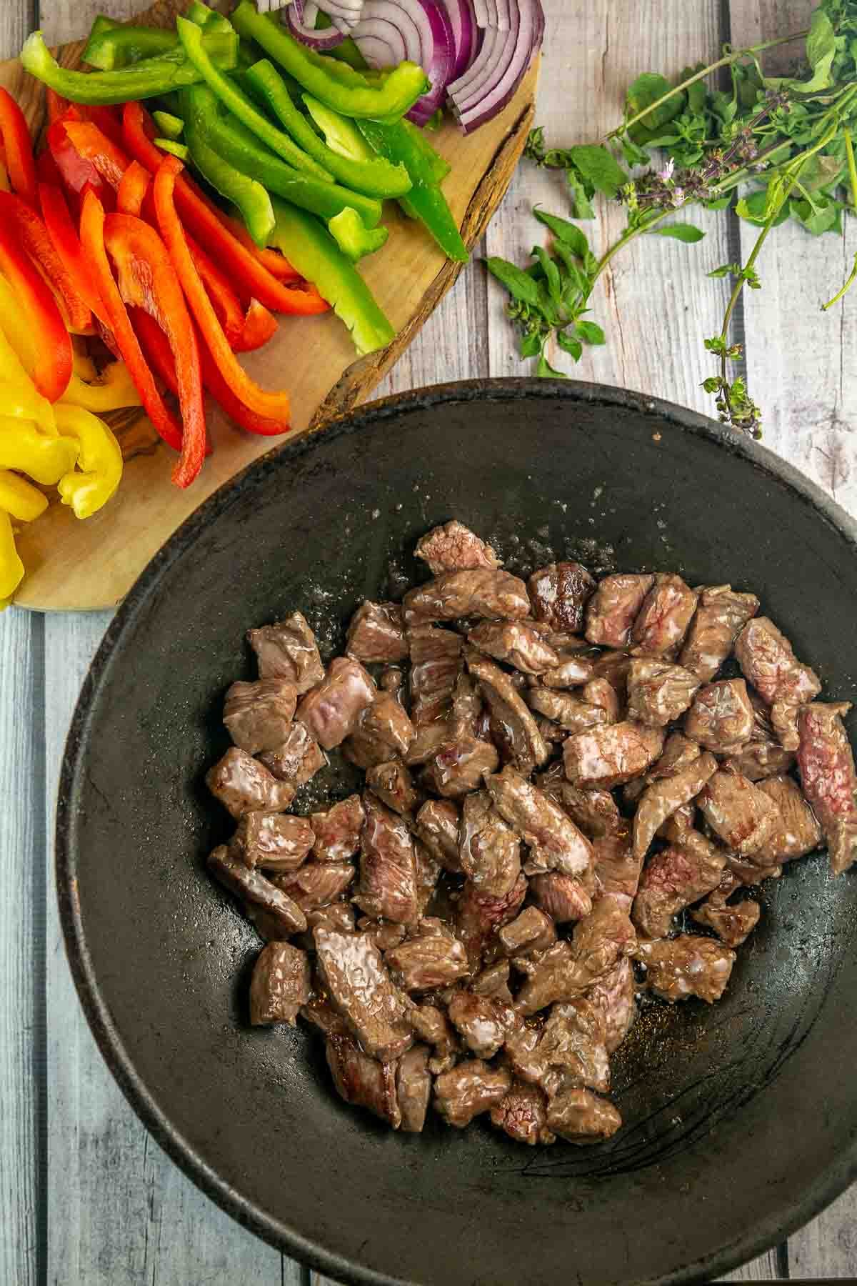 browned stir fried beef in a large wok