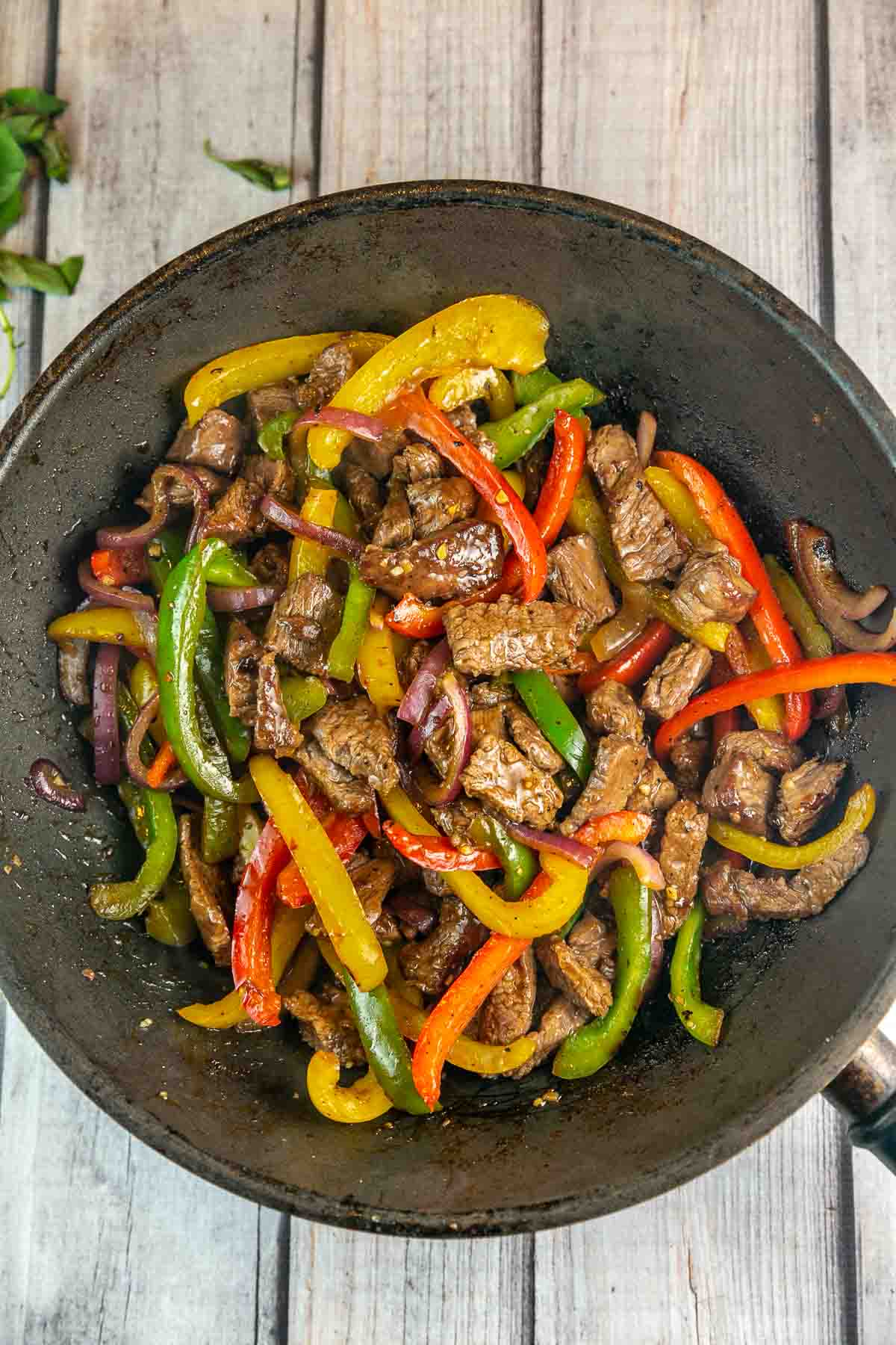 stir fried beef and peppers in a large wok