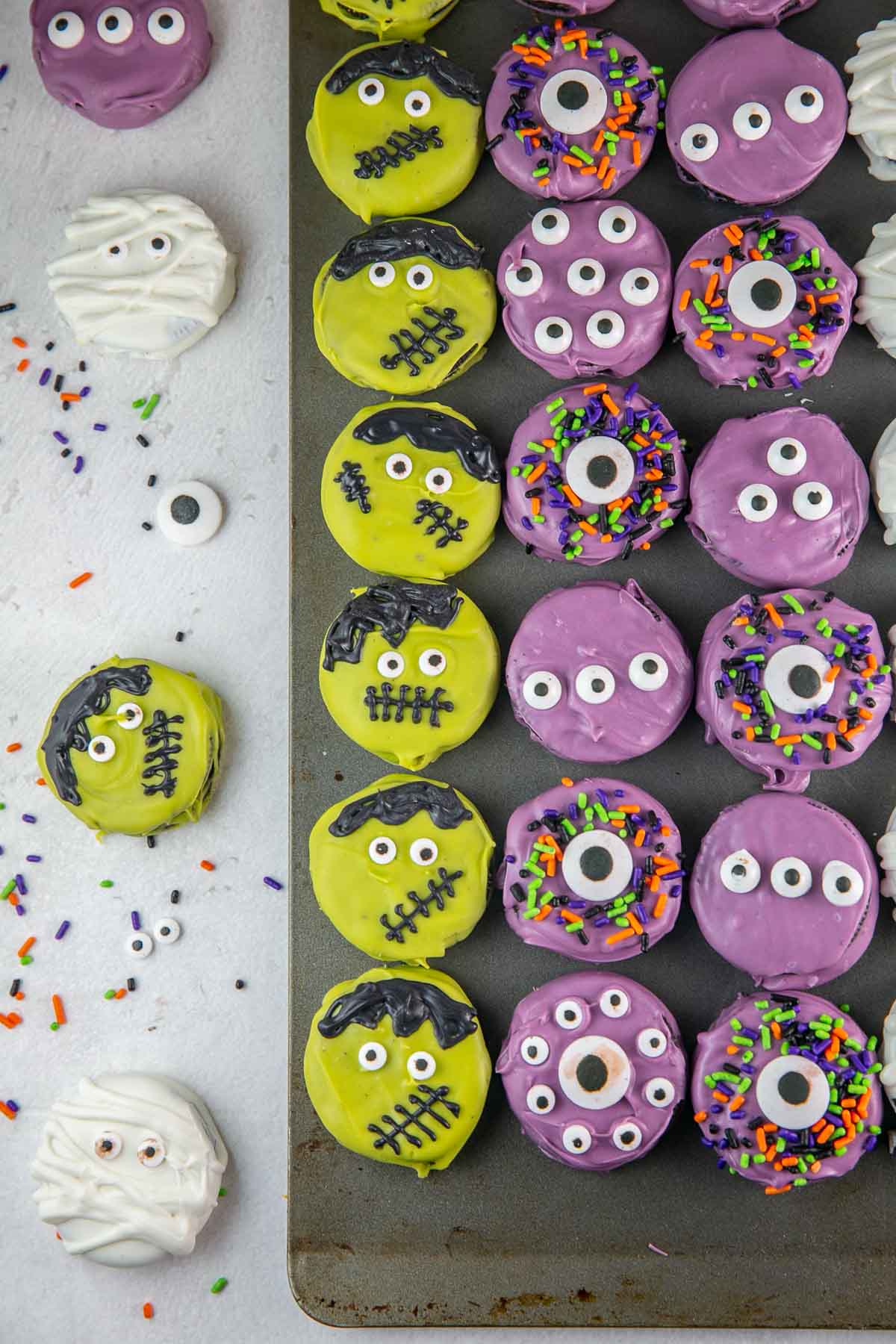 oreo cookies decorated to look like Frankenstein and purple monsters.