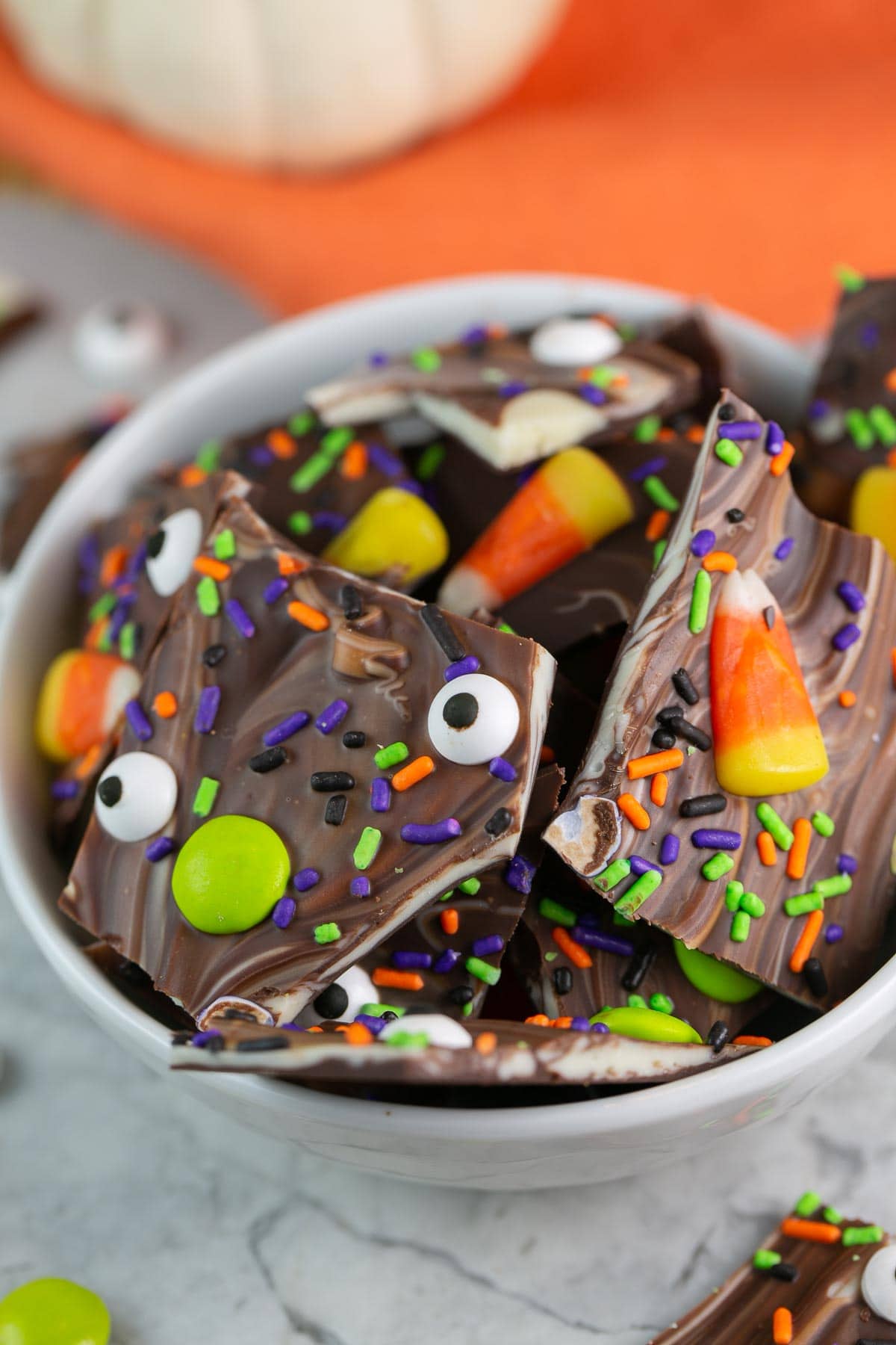 broken pieces of chocolate bark turned into boo bark with Halloween toppings.