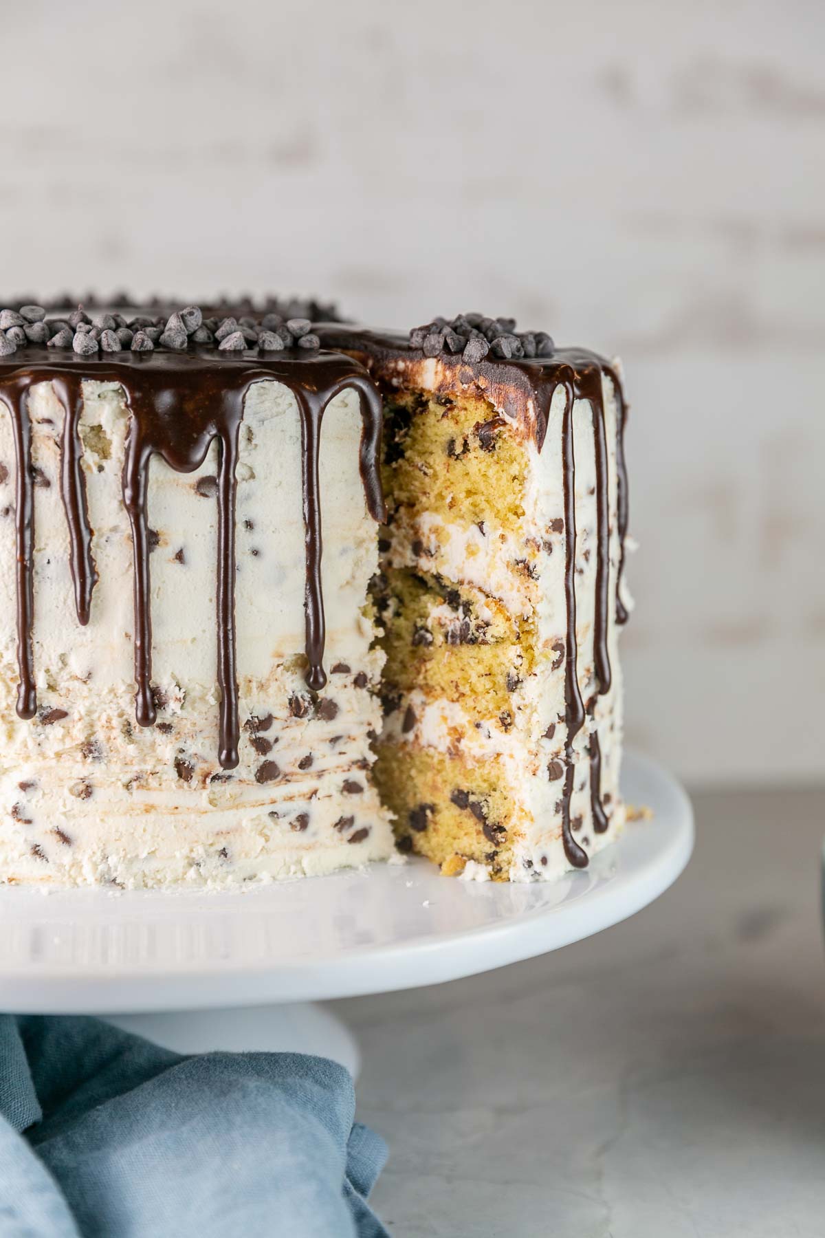 one slice of chocolate chip cake being removed from the whole cake