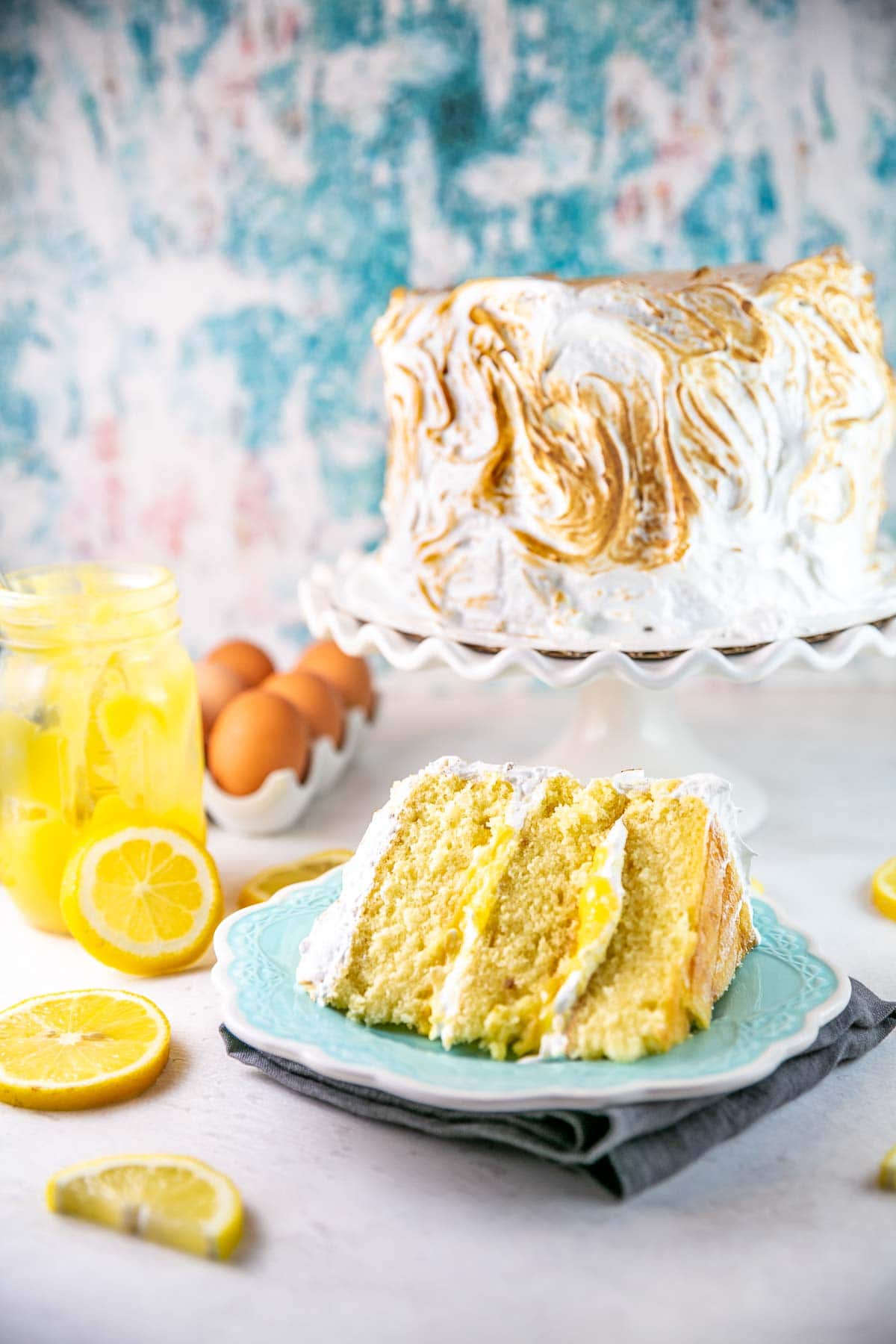 slice of lemon meringue cake on a blue dessert plate