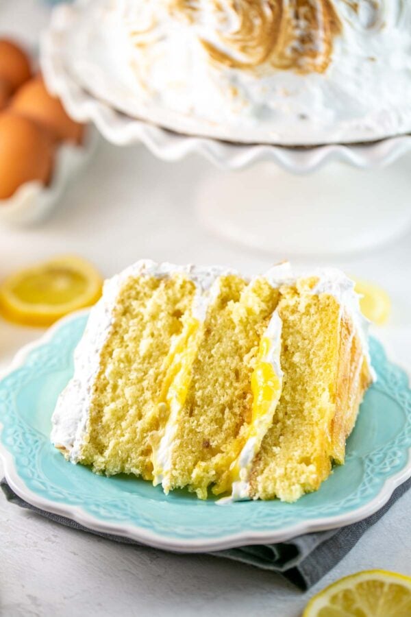 slice of cake on its side with lemon curd visible between the layers