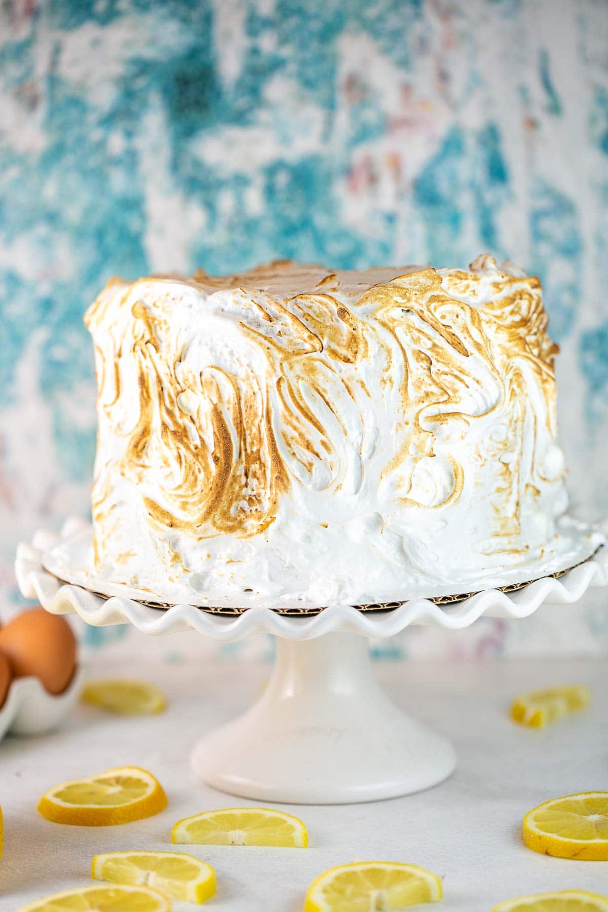 three layer lemon cake covered with swirls of toasted meringue