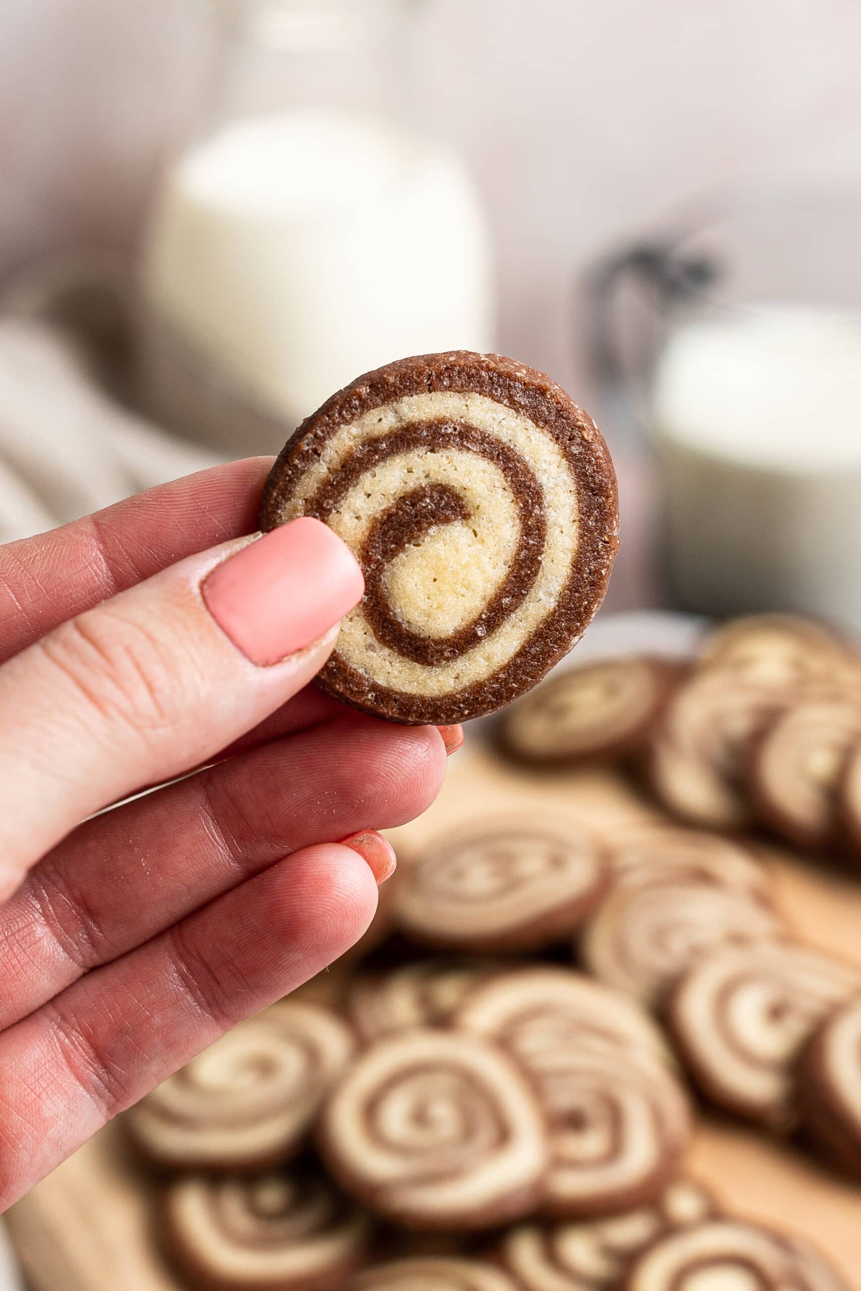 one cookie held up by a hand to show the size of the finished cookies