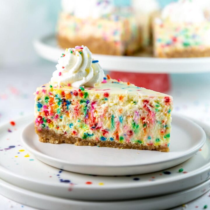 slice of funfetti cheesecake filled with brightly colored sprinkles
