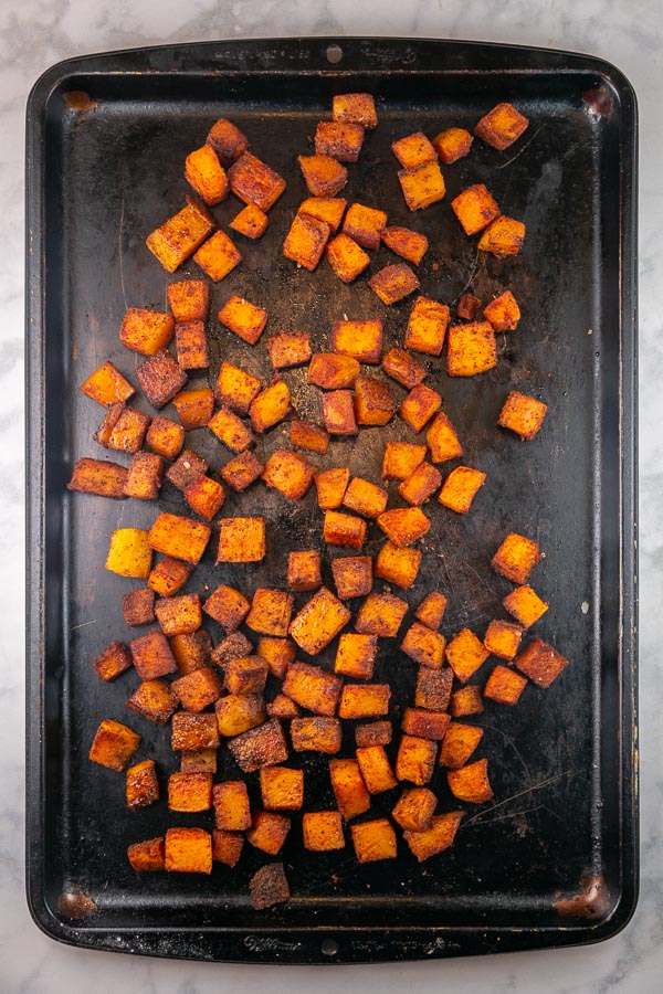 sheet pan with browned roasted butternut squash.