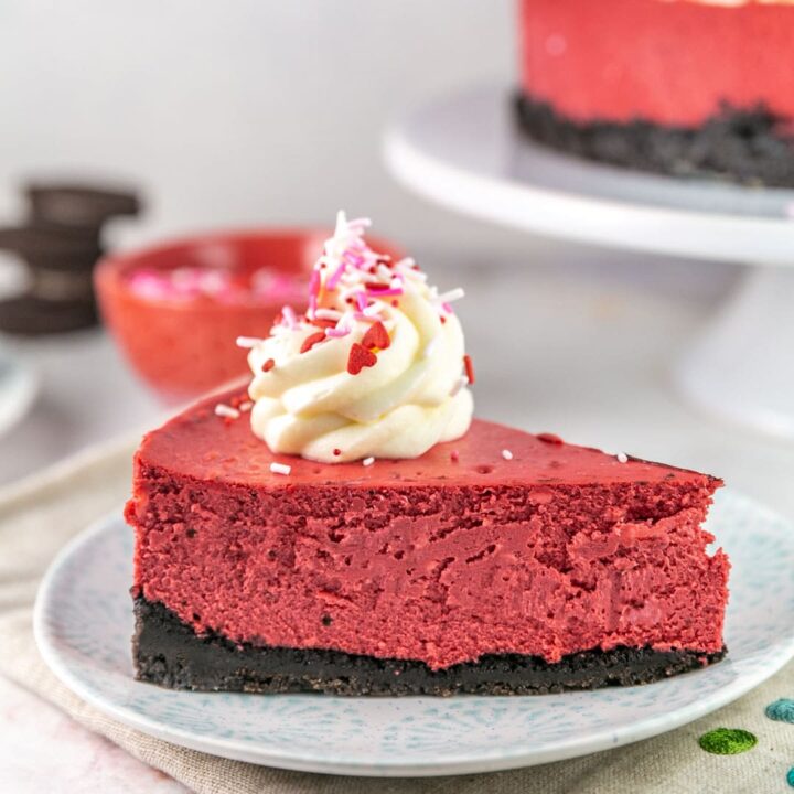 slice of red velvet cheesecake with a swirl of cream cheese frosting